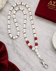 Close-up detail of pearl beads rhinestone spacers and crimson accent beads on Delta Sigma Theta lanyard necklace
