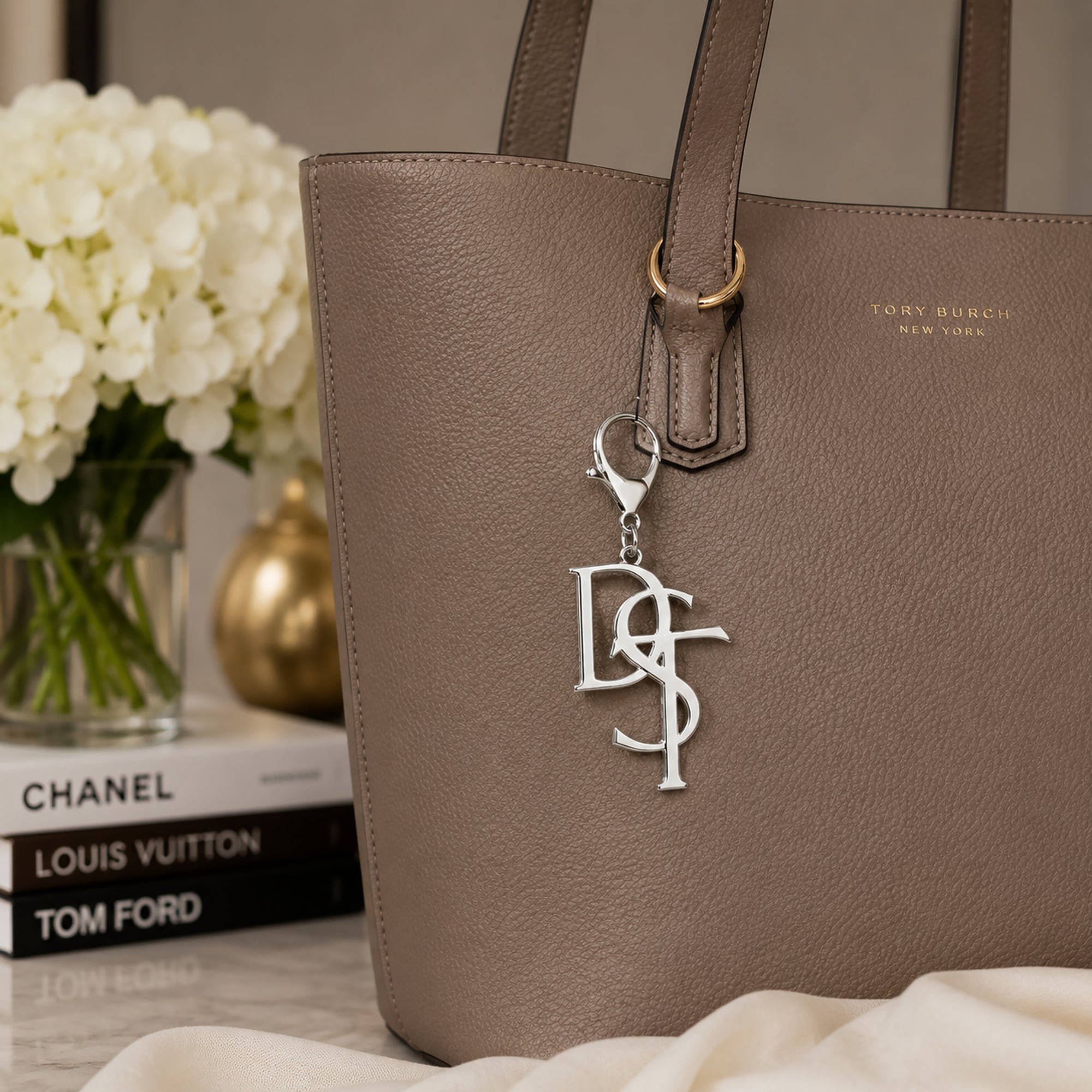 Delta Sigma Theta DST silver monogram keychain charm clipped to taupe tote bag