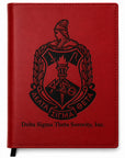 Red notebook with Delta Sigma Theta Sorority, Inc. emblem on a white background
