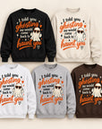 Five crewneck sweatshirts in black, cream, white, gray, and brown, each printed with a humorous ghost-themed quote in orange and white, featuring a cartoon ghost wearing sunglasses.