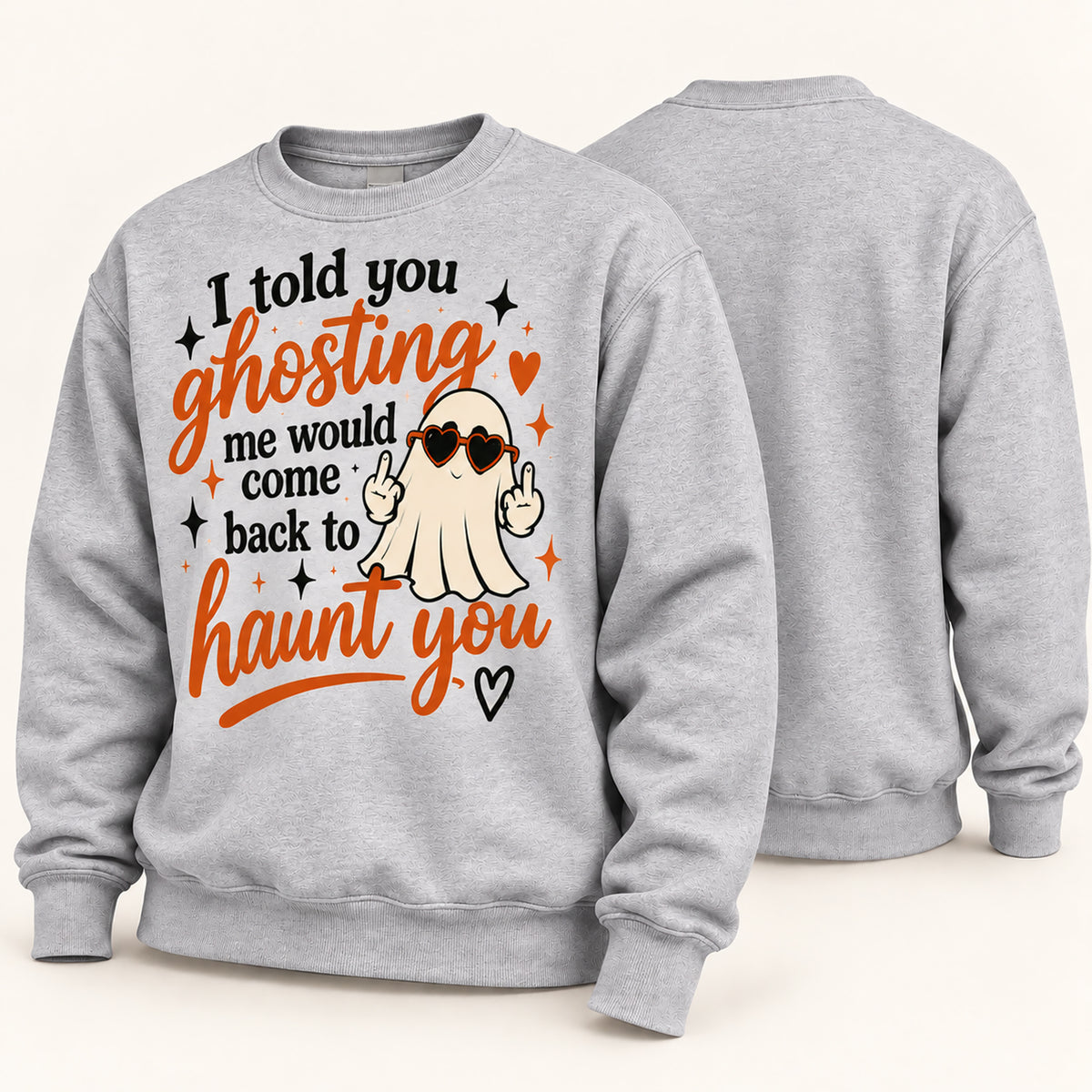 A light heather gray crewneck sweatshirt shown from both front and back. The front features a graphic of a cartoon ghost wearing heart-shaped sunglasses and making a peace sign, surrounded by the text 'I told you ghosting me would come back to haunt you' in black and orange lettering.