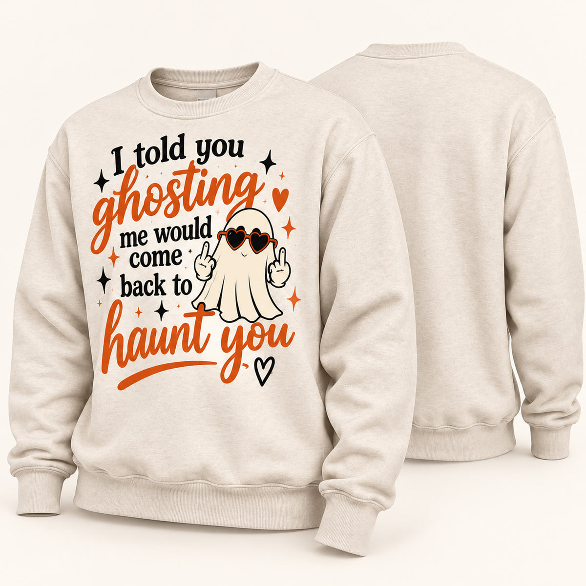 A light beige crewneck sweatshirt shown from both front and back. The front features a Halloween-themed graphic with the text 'I told you ghosting me would come back to haunt you' in black and orange lettering, a cartoon ghost wearing heart-shaped sunglasses, and small orange and black stars.