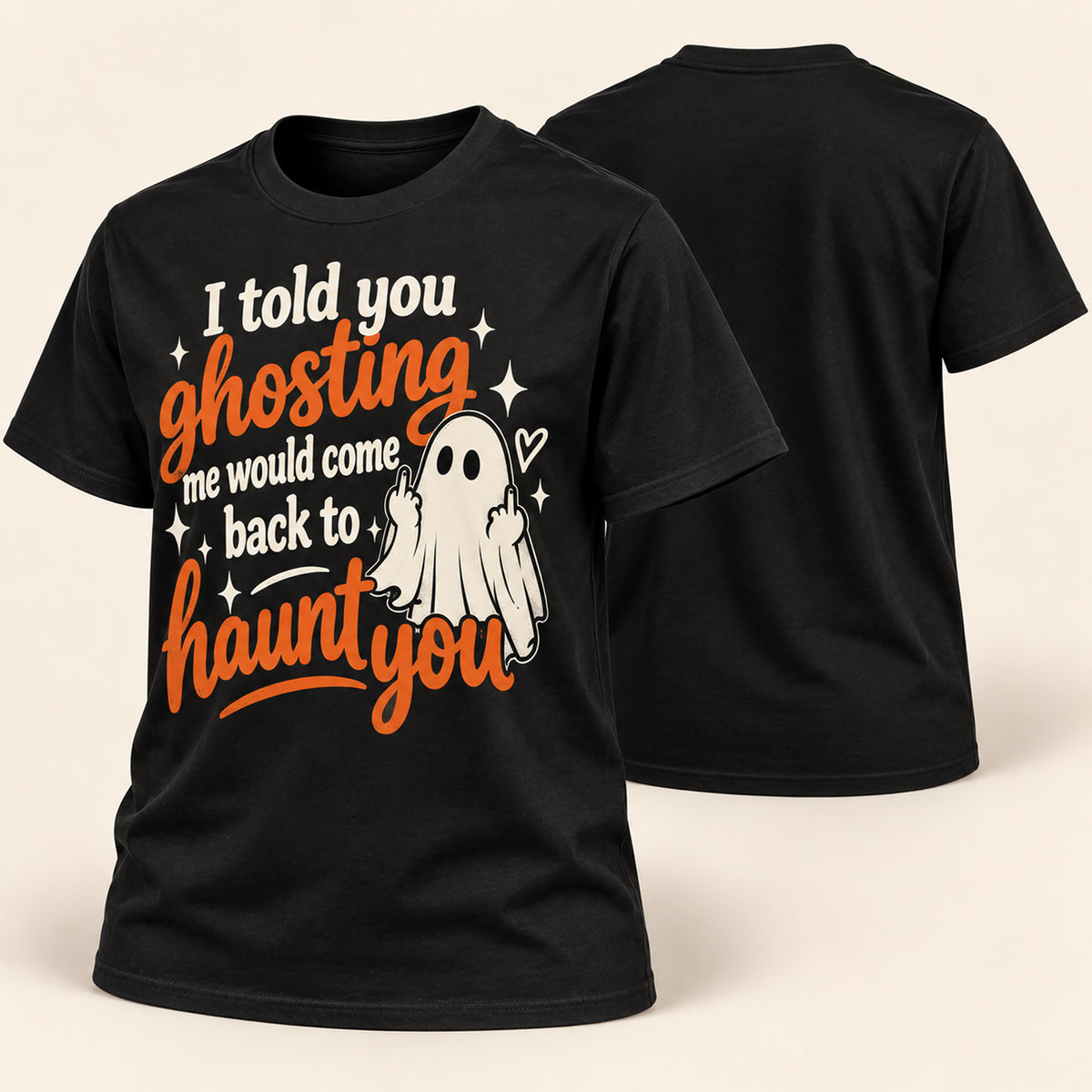 A black short-sleeve graphic T-shirt shown from the front and back on a light beige background. The front features a Halloween-themed print with the phrase 'I told you ghosting me would come back to haunt you' in orange and white lettering, alongside a white ghost illustration and small white stars.