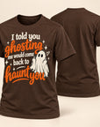 A dark brown short-sleeve t-shirt shown from both the front and back. The front features a Halloween graphic with the text 'I told you ghosting me would come back to haunt you' in white and orange lettering, accompanied by an illustration of a white ghost.