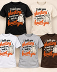 Six short-sleeve graphic T-shirts shown in different colors: black, cream, white, light gray, medium gray, and dark brown. Each shirt features a Halloween-style ghost graphic and the text, 'I told you ghosting me would come back to haunt you,' in orange, black, and white.