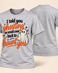 A heather gray short-sleeve t-shirt shown from both front and back. The front features a Halloween graphic with the text 'I told you ghosting me would come back to haunt you' in black and orange lettering, alongside a small white ghost illustration.
