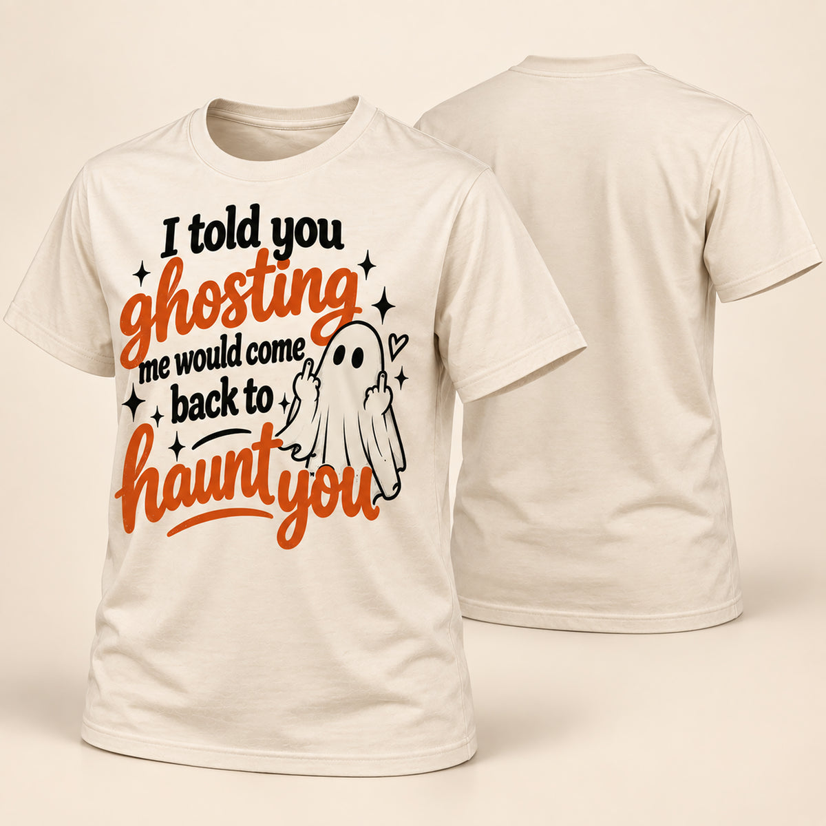 A cream-colored short-sleeve t-shirt shown from both the front and back. The front features a Halloween graphic with the text 'I told you ghosting me would come back to haunt you' in black and orange lettering, alongside a small white cartoon ghost.