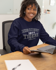 Woman wearing navy unisex crewneck sweatshirt with Tigers Alumni chest graphic
