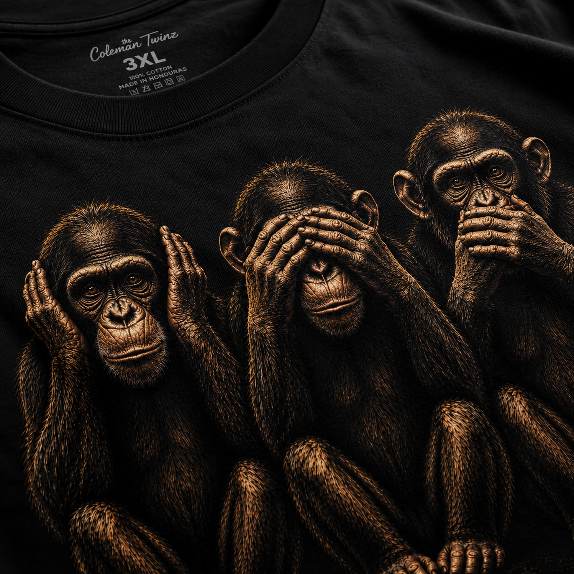 Close-up detail image of hear no evil see no evil speak no evil monkey graphic printed on black t-shirt
