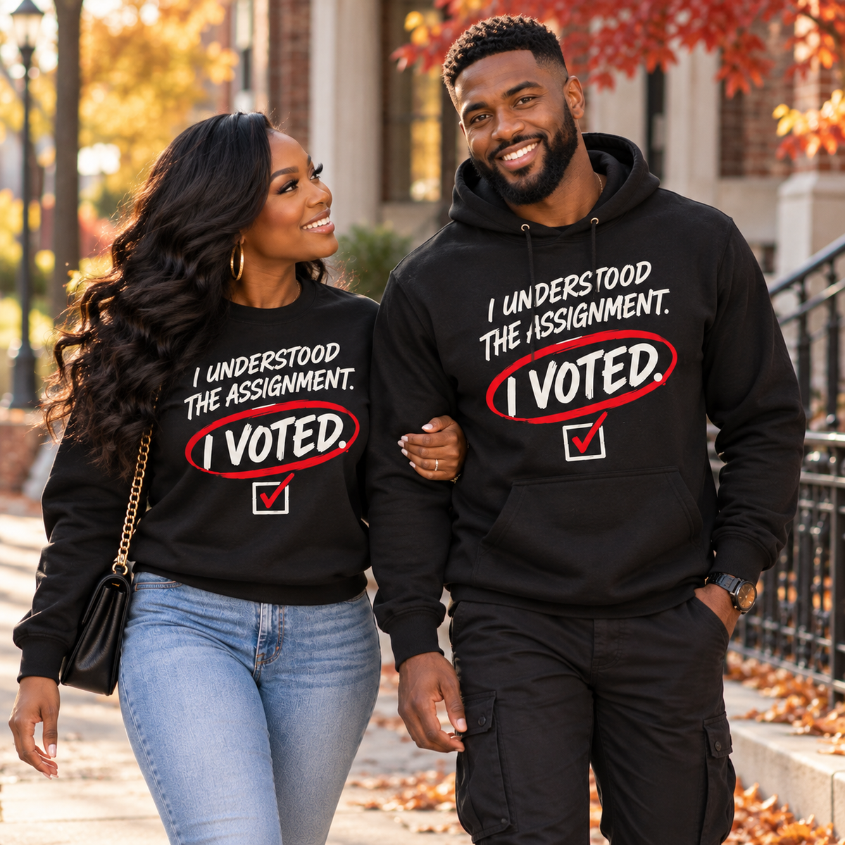 Black adults wearing I Understood the Assignment I Voted crewneck sweatshirt and hoodie