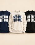 If You See One Hit One graphic crewneck sweatshirts in navy blue, natural and black.