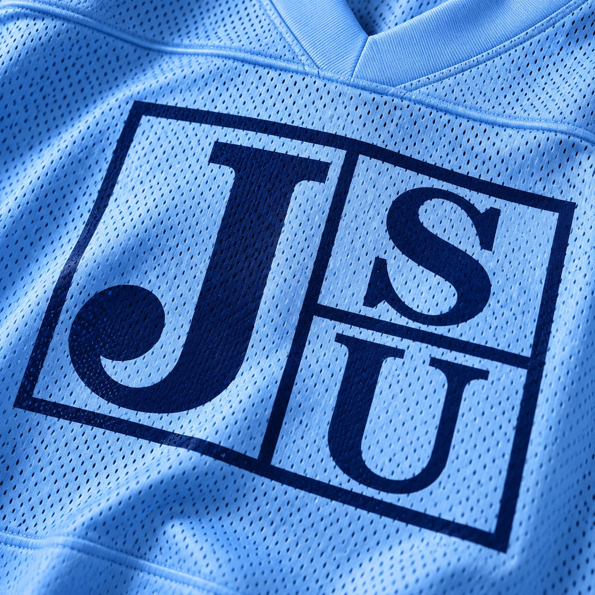 Close-up of Jackson State Block Letter JSU design on Carolina blue mesh jersey