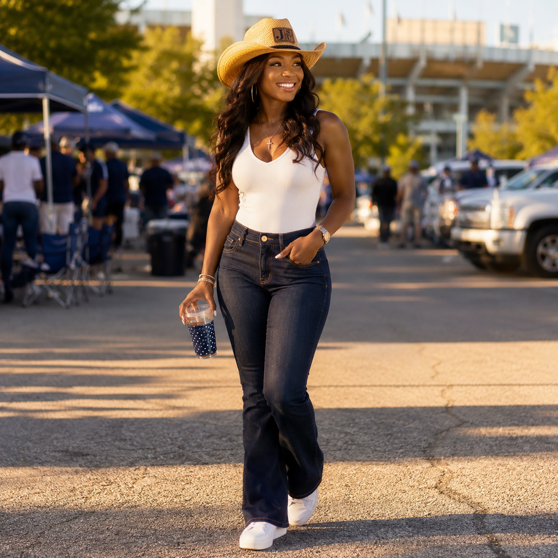Woman wearing Jackson State Block Letter cowboy straw hat at an outdoor game day tailgate