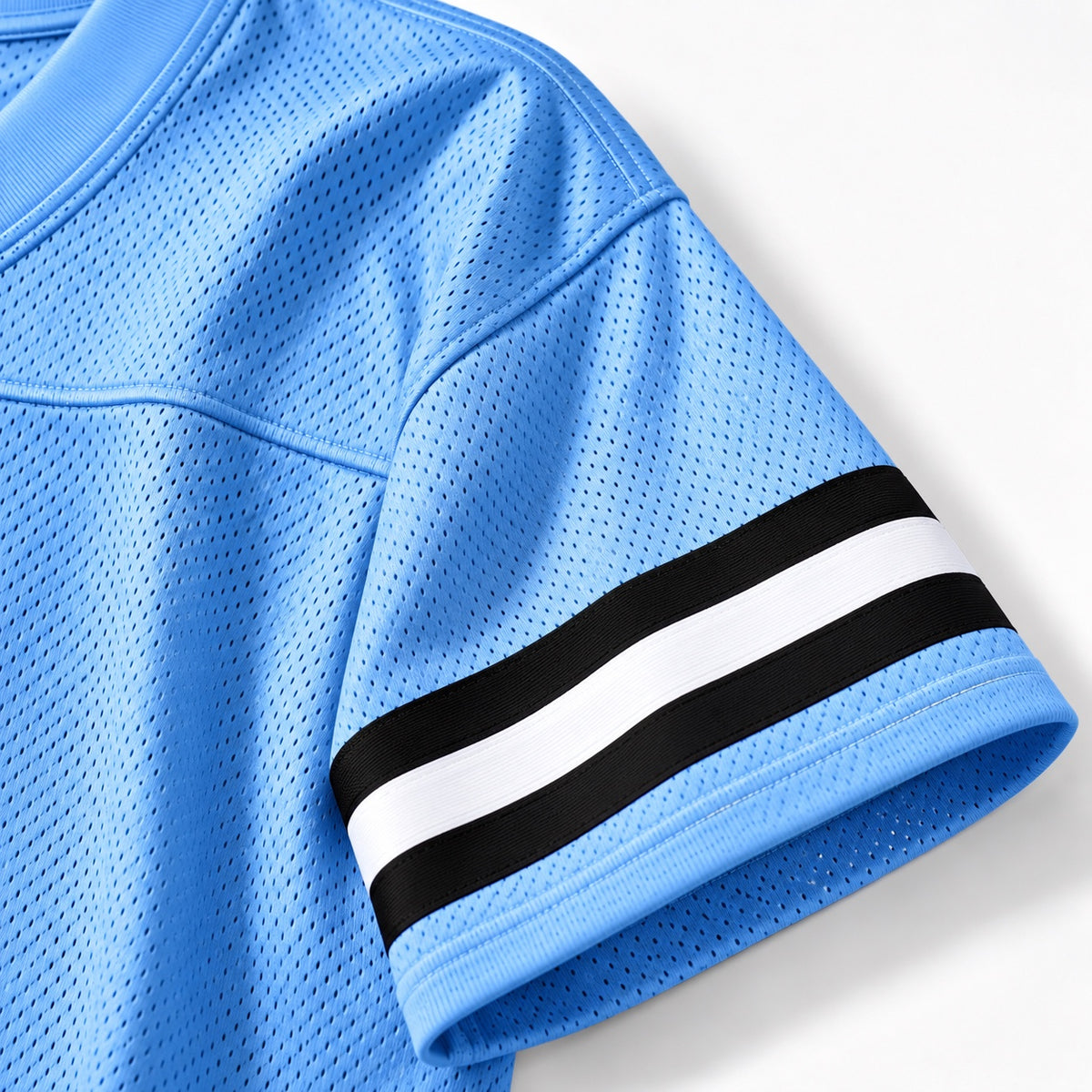 Close-up of Carolina blue Jackson State cropped mesh football jersey sleeve and stripe detail