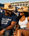 Black couple wearing Jackson State University JSU cowboy straw hats at a football game day tailgate.