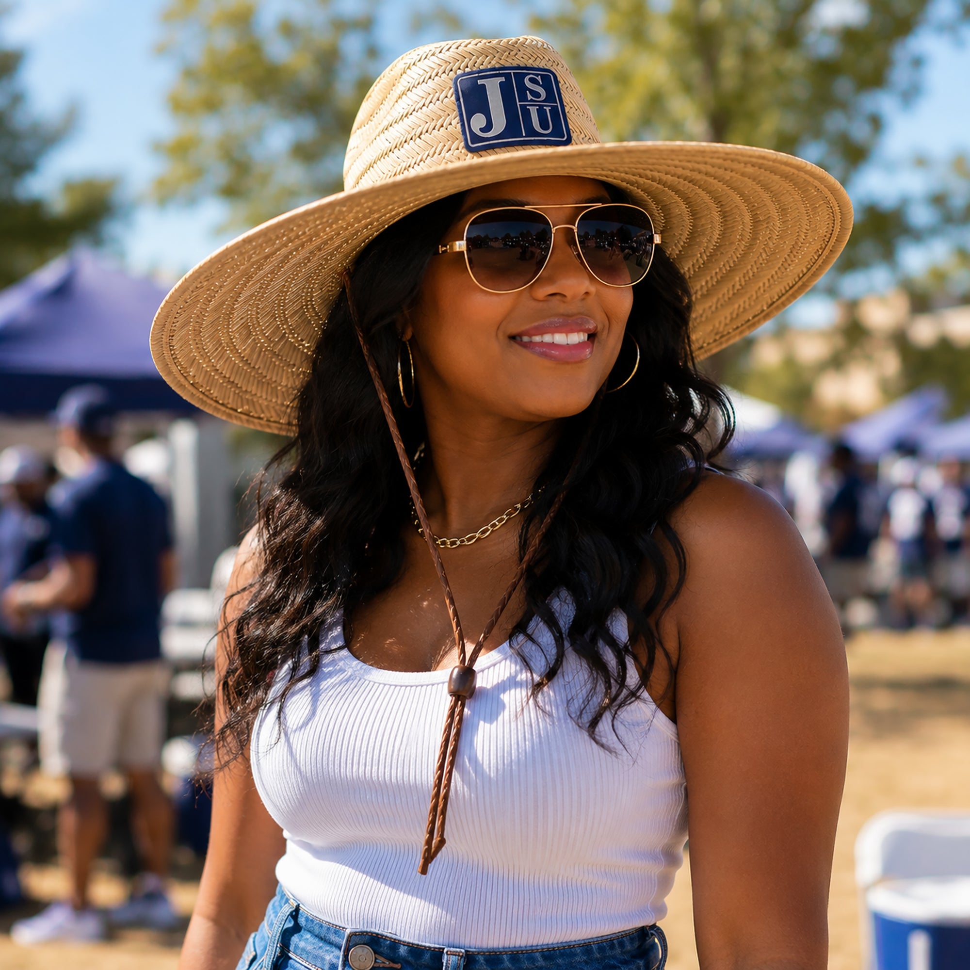 Woman wearing Jackson State JSU wide brim straw lifeguard hat with navy blue and silver leatherette patch