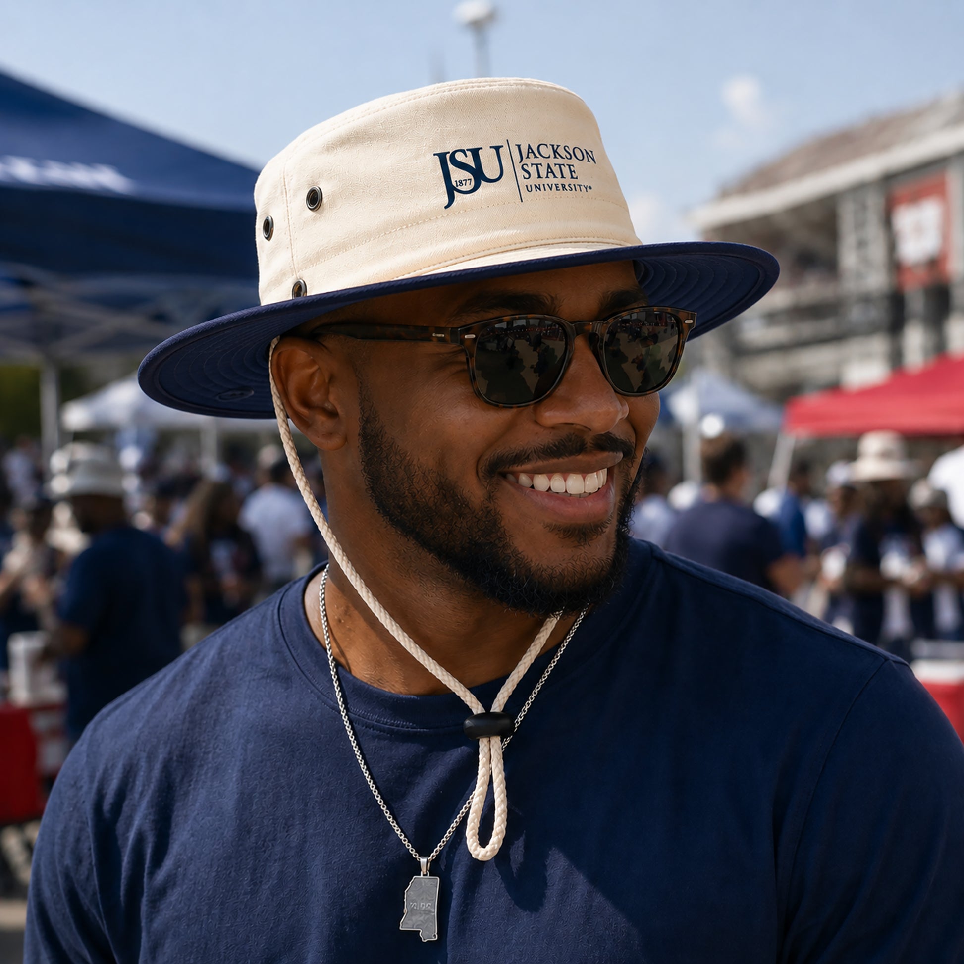 Jackson State supporter wearing Canvas Navy JSU Outback Hat at an outdoor football tailgate
