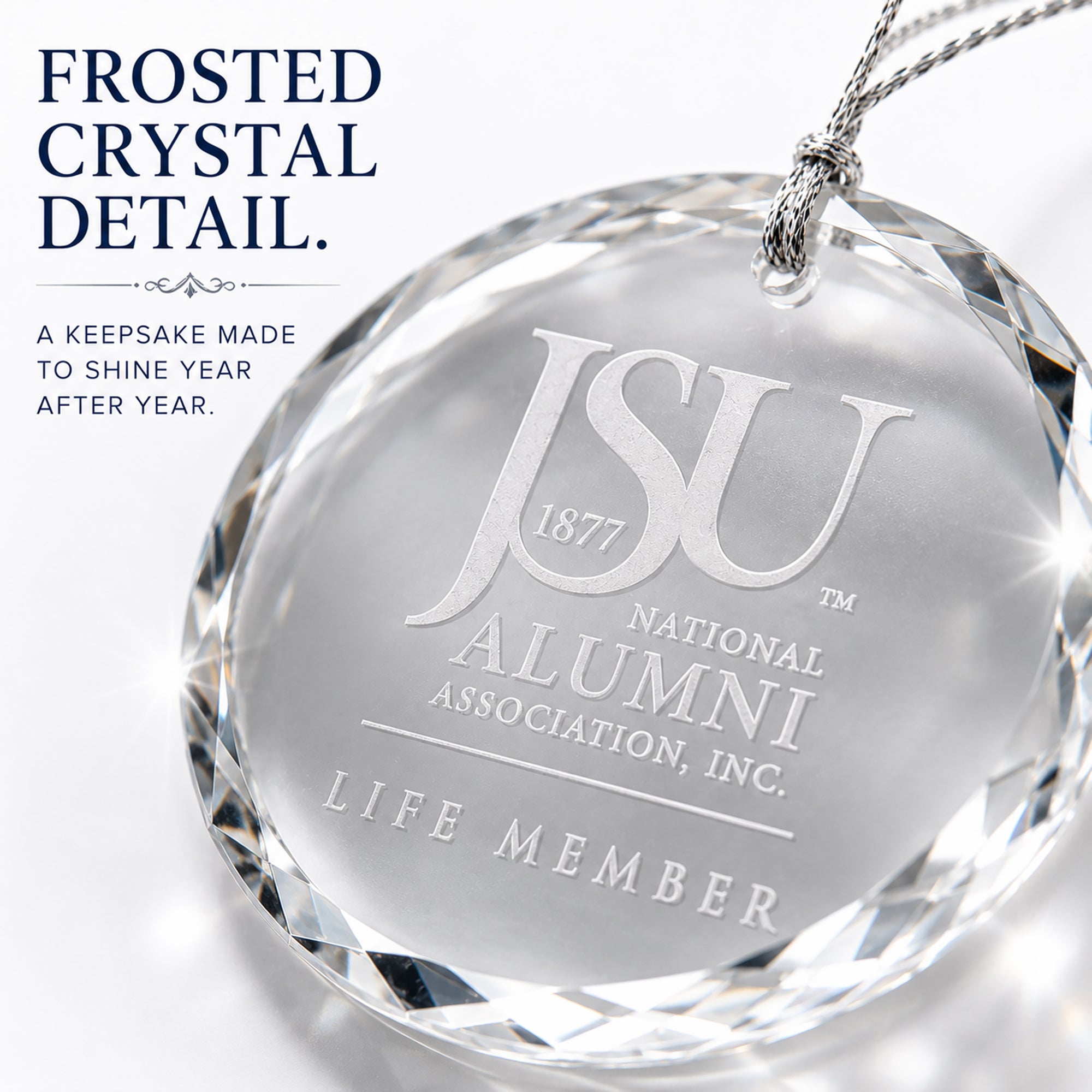 Close-up of frosted laser engraving and faceted edges on the Jackson State University Life Member crystal ornament.
