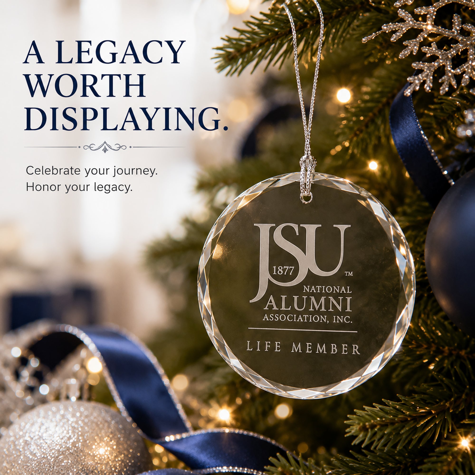 Jackson State University Life Member crystal ornament hanging on a Christmas tree with elegant navy and silver holiday decor.