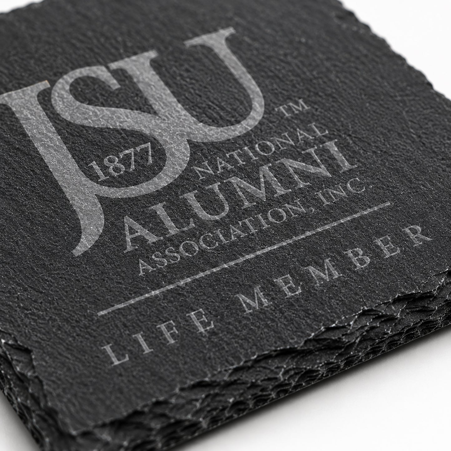 Close-up of a Jackson State University Life Member engraved slate coaster highlighting the crisp laser engraving, natural slate texture, and chipped stone edges.