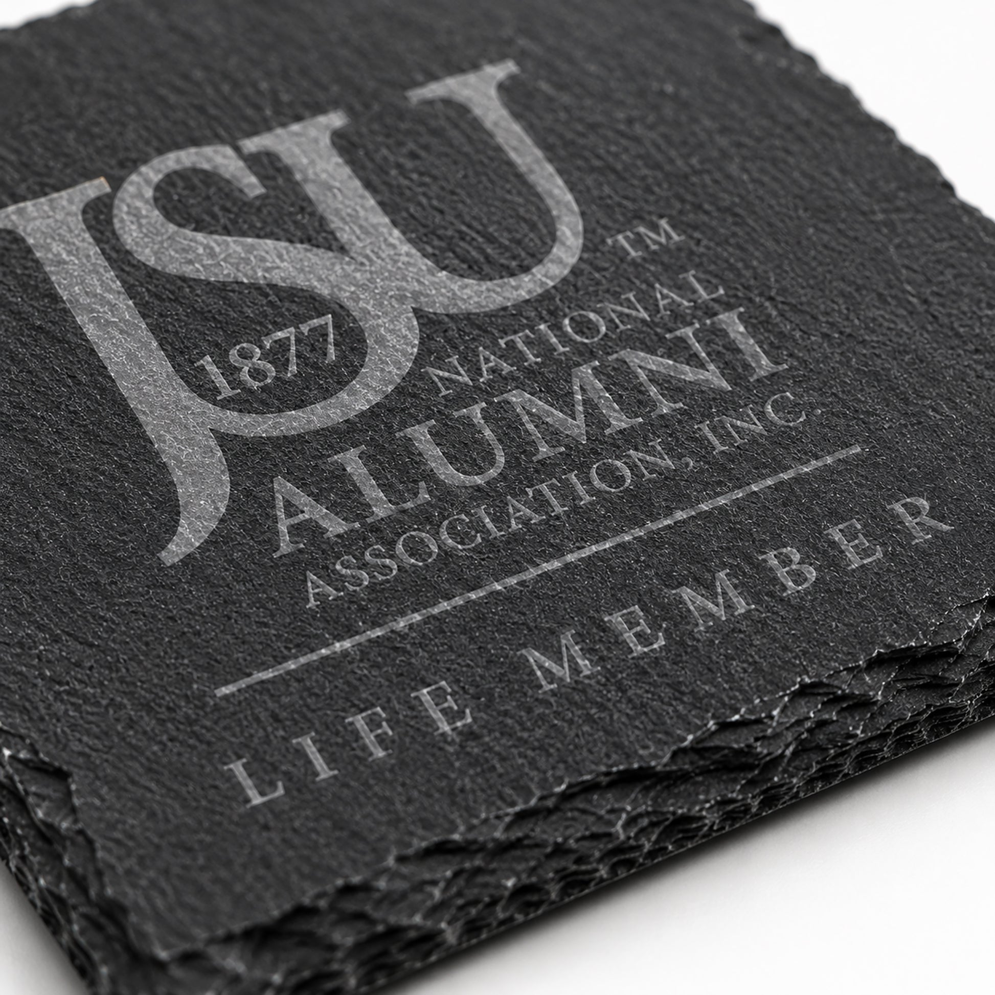 Close-up of a Jackson State University Life Member engraved slate coaster highlighting the crisp laser engraving, natural slate texture, and chipped stone edges.