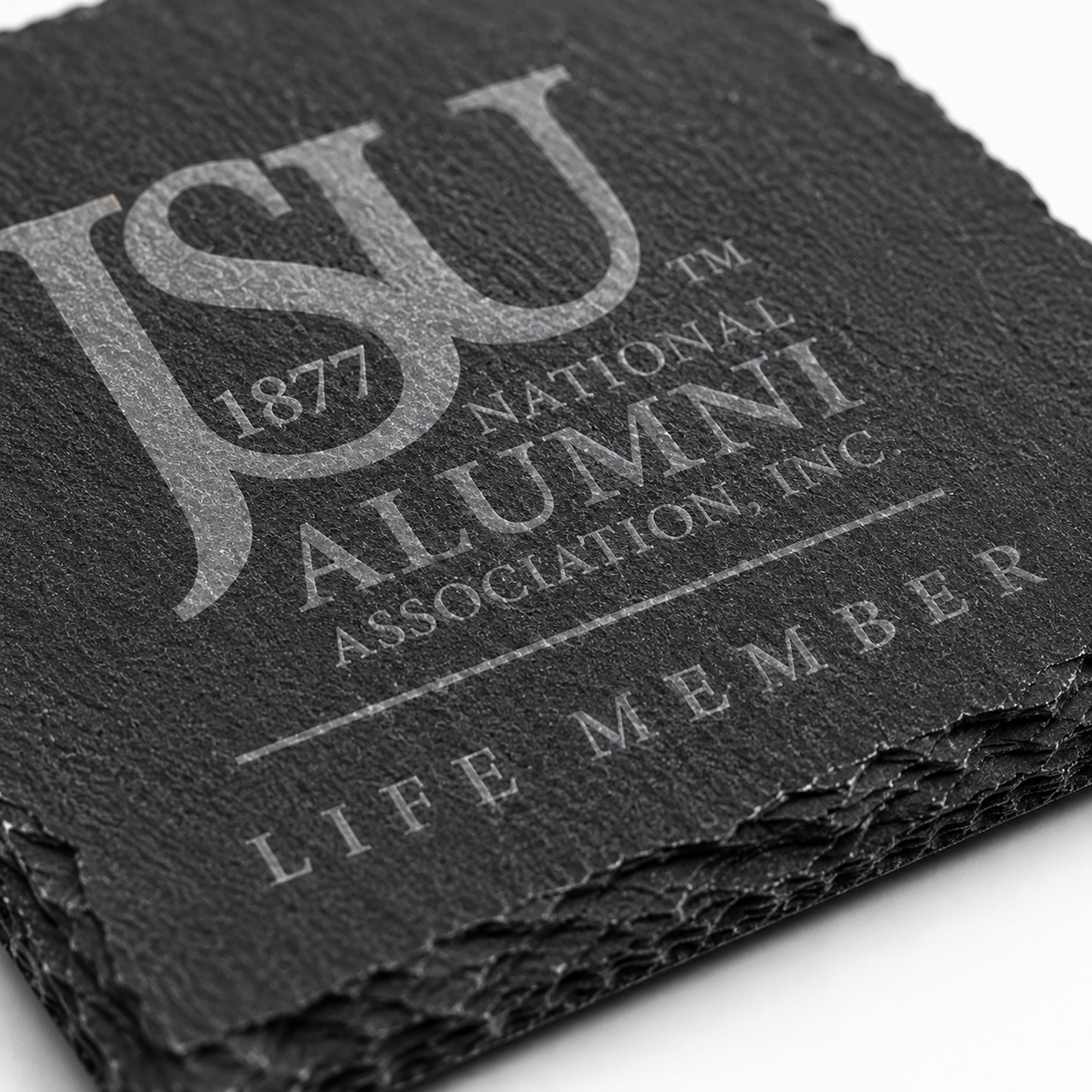 Close-up of a Jackson State University Life Member engraved slate coaster highlighting the crisp laser engraving, natural slate texture, and chipped stone edges.