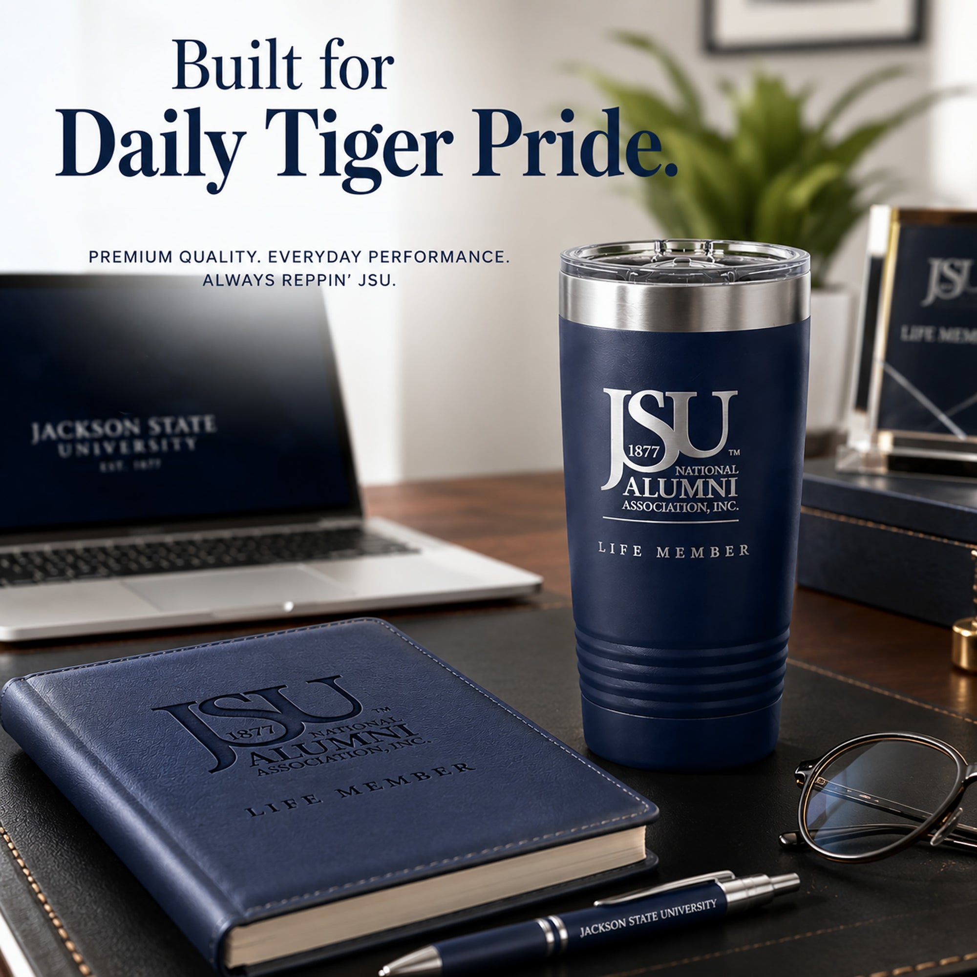 Jackson State University Life Member navy tumbler on an executive desk with laptop and notebook.