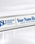 A silver aluminum desk nameplate with a white front panel, featuring the blue Jackson State University logo and customizable text reading 'Your Name Here' and 'Your Title Here'.