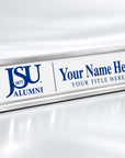 A silver aluminum desk sign with a white faceplate, featuring the blue 'JSU 1877 ALUMNI' logo and customizable blue placeholder text reading 'Your Name Here' and 'YOUR TITLE HERE'.