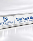 A silver metal desk nameplate with a white front panel, featuring the blue 'JSU Jackson State University' logo on the left and customizable blue placeholder text on the right, shown on a reflective white surface.