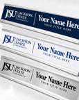 Three custom desk nameplates with Jackson State University branding, shown at different angles on a light gray background. The nameplates feature navy blue, white, and brushed silver metallic finishes with customizable text placeholders.
