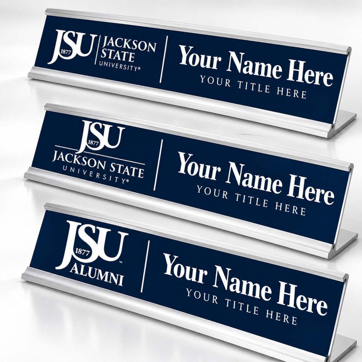 Three custom desk nameplates with a dark blue background and silver metal frames, featuring the Jackson State University logo and customizable text.
