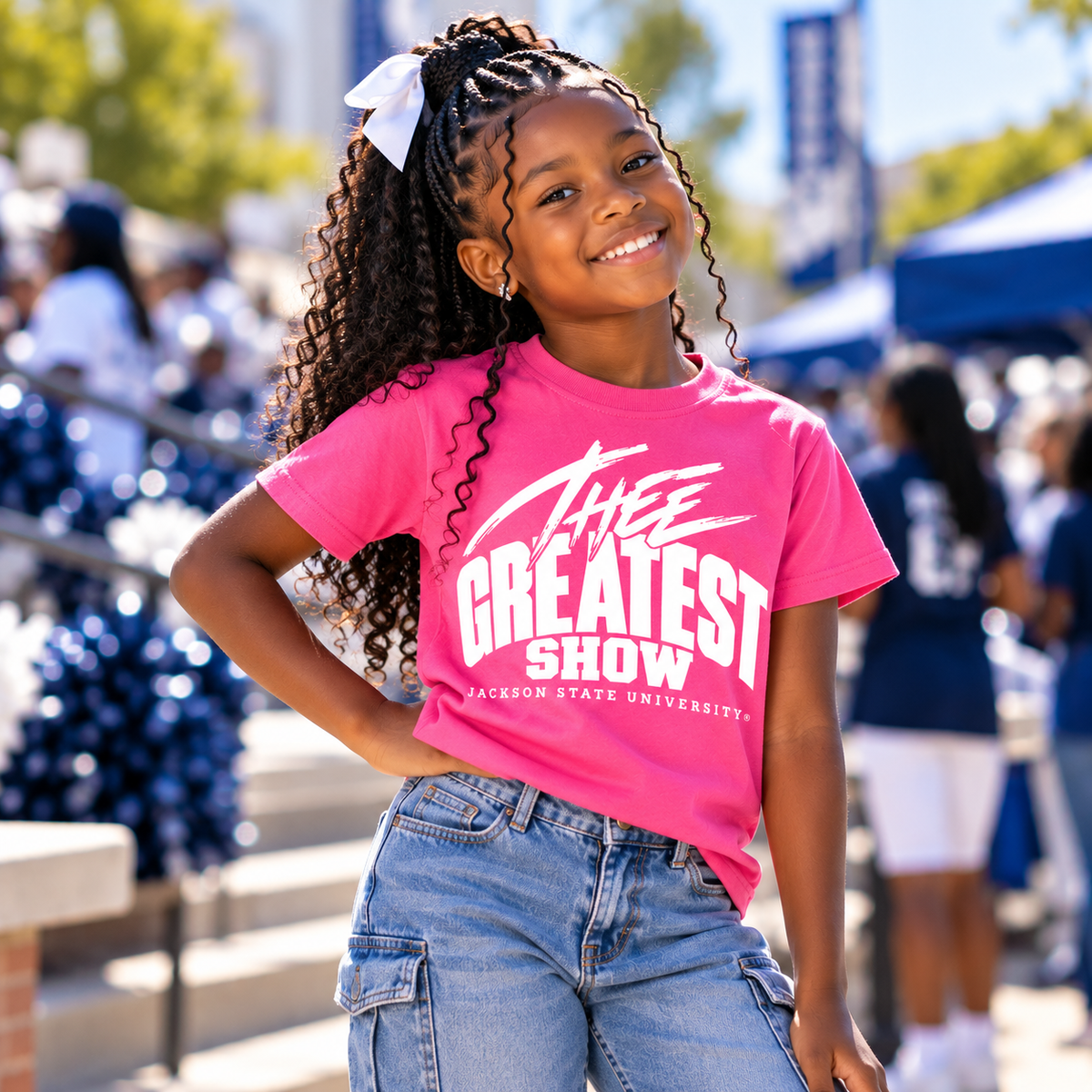 Girl wearing Jackson State Tigers Thee Greatest Show pink youth T-shirt