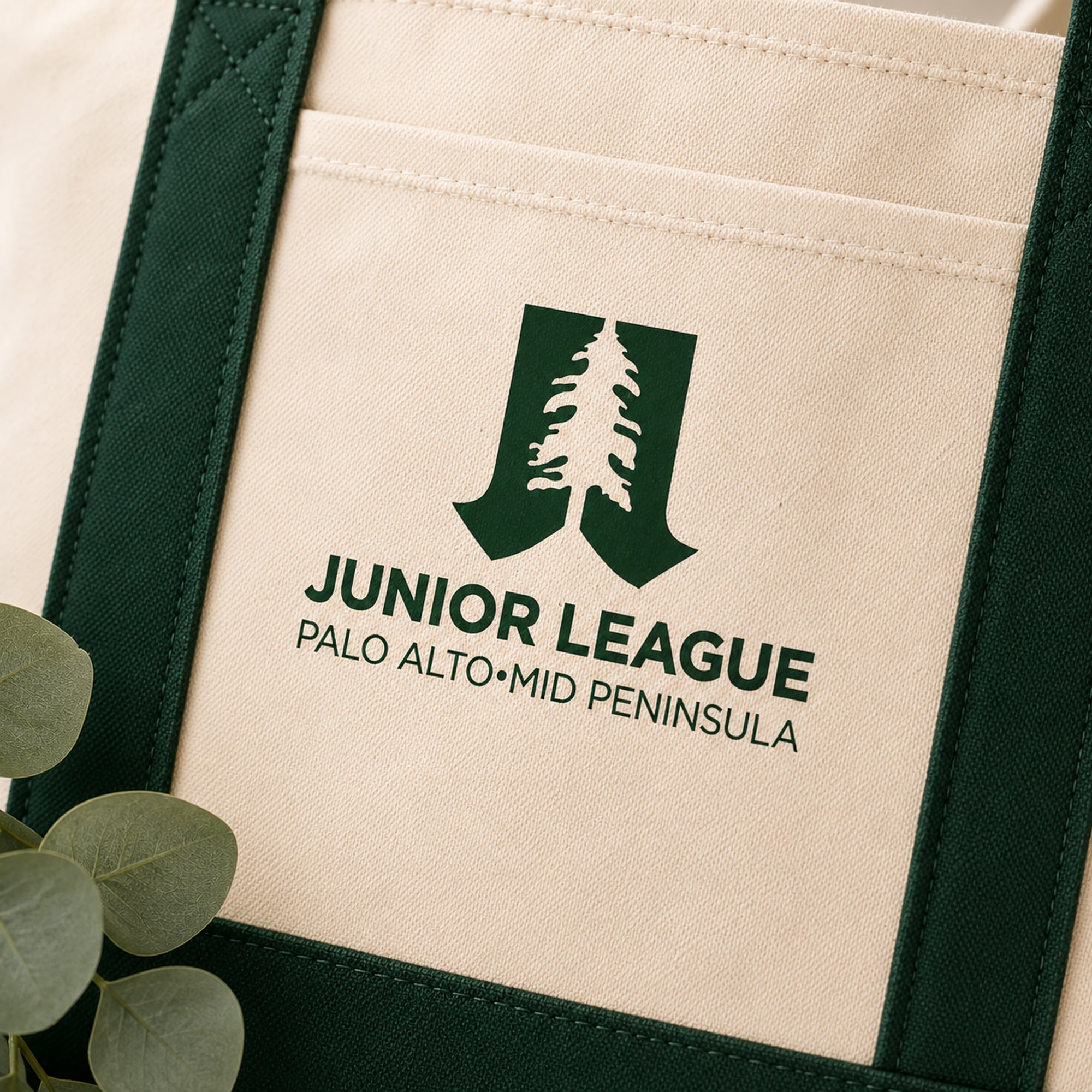 Close-up detail of Junior League Palo Alto Mid Peninsula tote bag logo and fabric texture