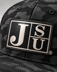 Close-up of Block JSU black-to-silver leatherette patch on Jackson State Black Camo New Era 9FIFTY hat