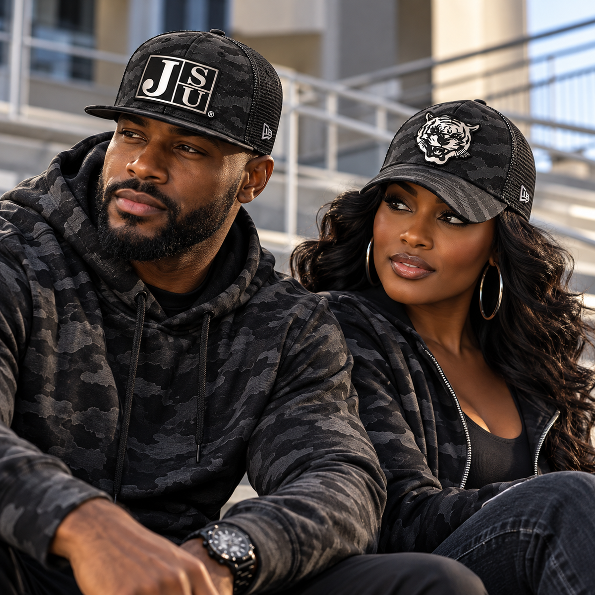 Black man and woman modeling Jackson State Black Camo New Era 9FIFTY and 39THIRTY patch hats