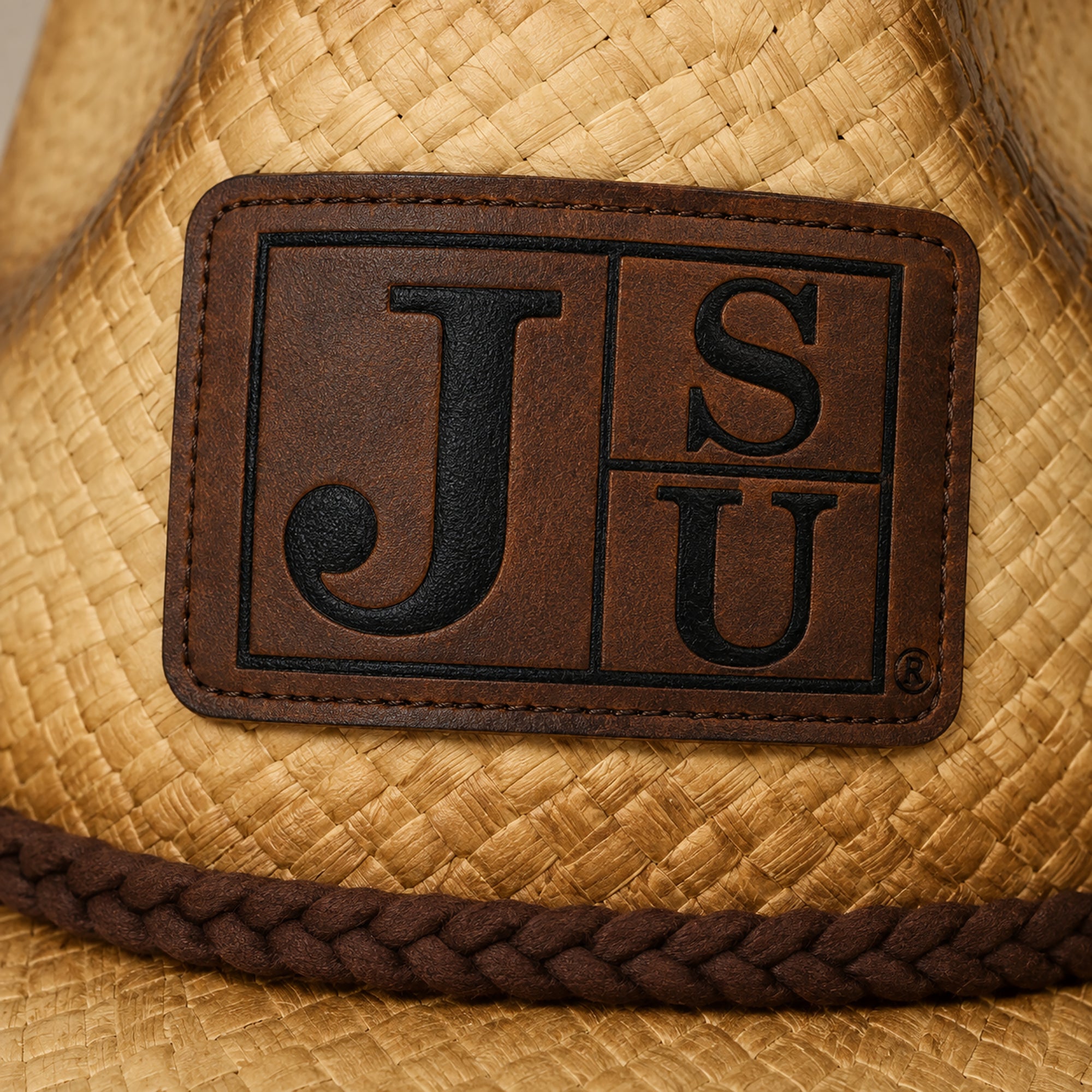 Close-up of engraved JSU Block Letter leatherette patch on cowboy straw hat