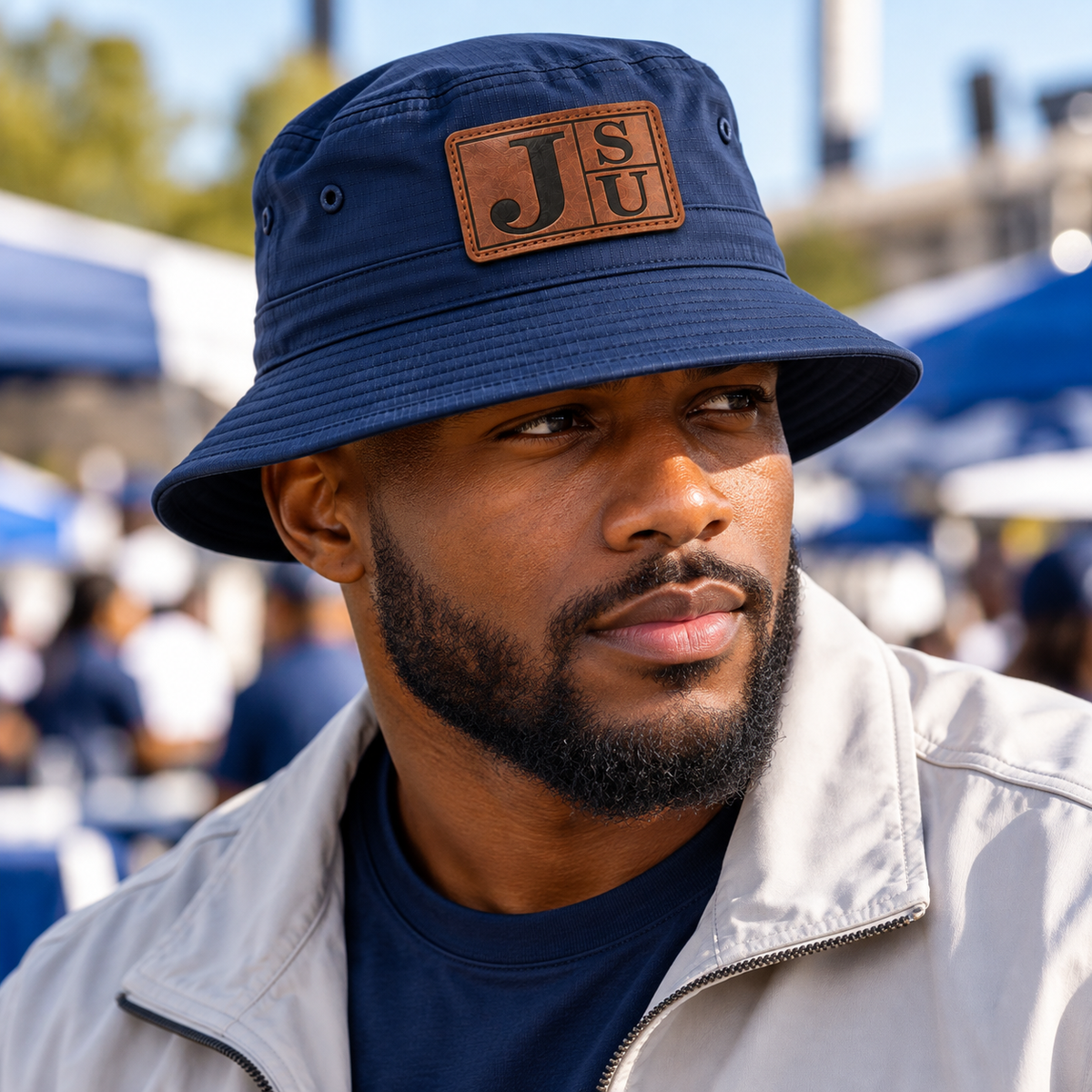 Black male model wearing Jackson State Tigers Dress Blue Navy outdoor bucket hat with walnut leatherette JSU patch