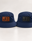 Dress Blue Navy Jackson State Tigers bucket hats comparing walnut and tonal black leatherette JSU patches
