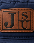 Close-up of walnut and black leatherette Jackson State JSU patch on Dress Blue Navy bucket hat