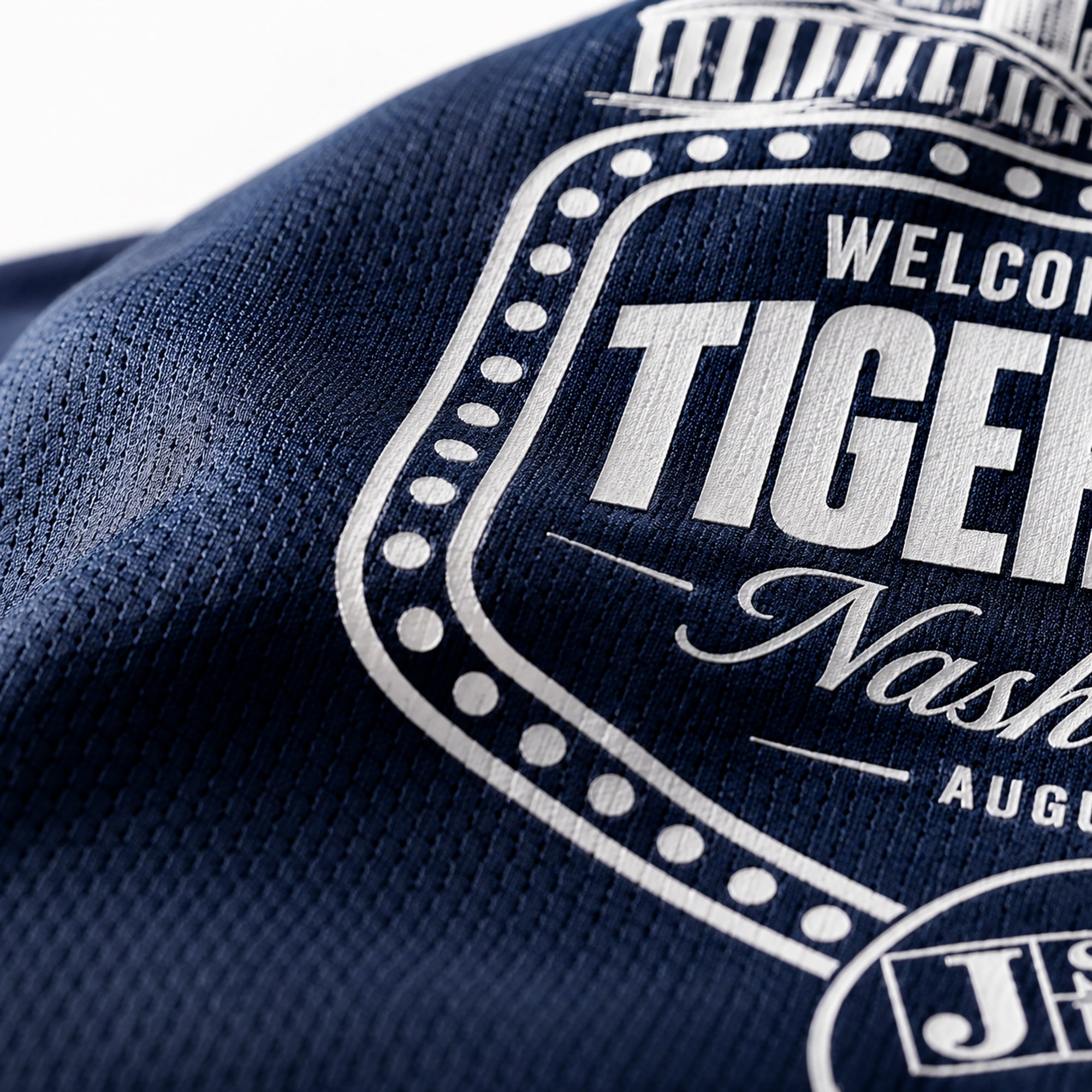 Close-up of navy performance t-shirt fabric with Tiger Takeover logo print