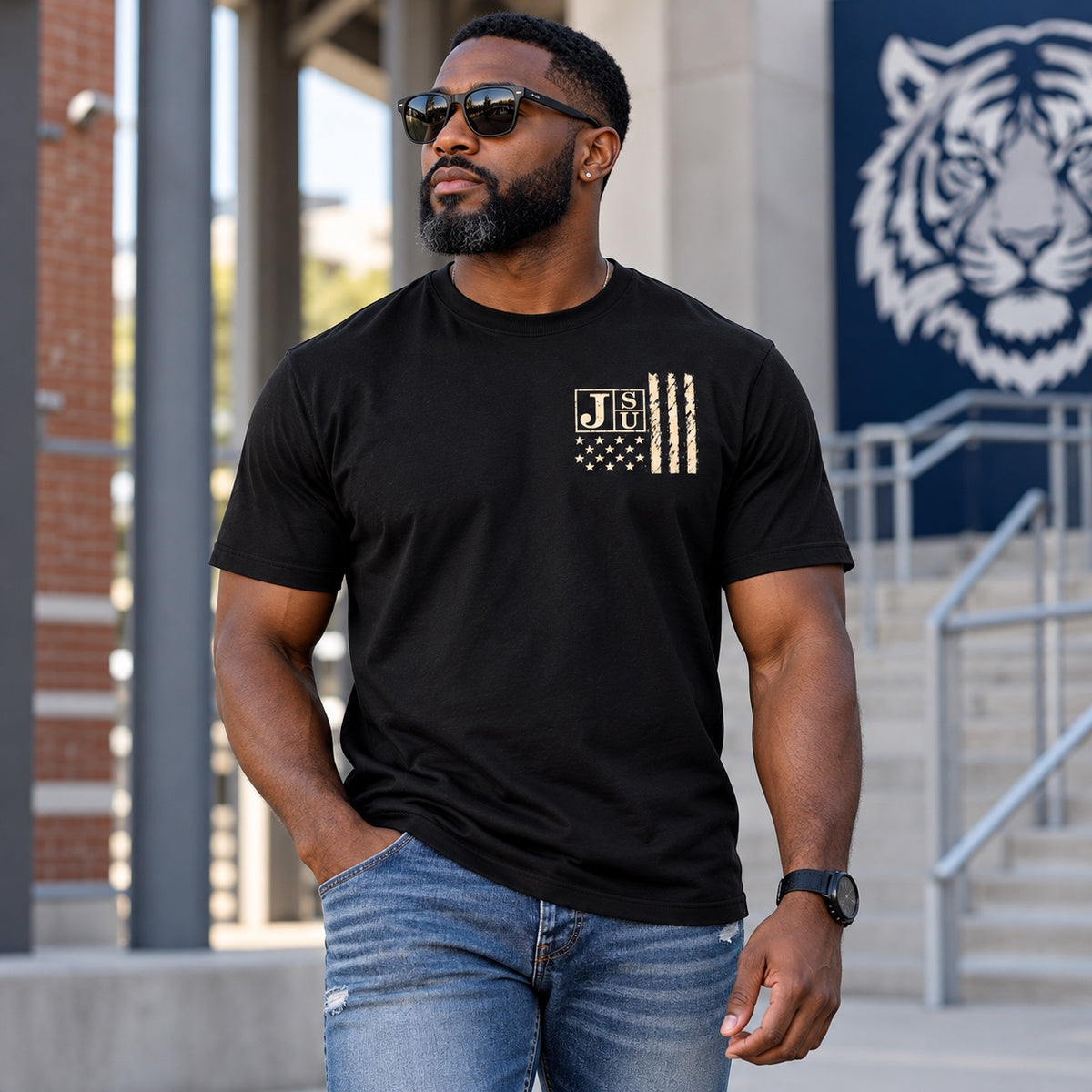 Black man wearing Jackson State Tigers Salute to Service black short sleeve T-shirt