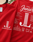 Close-up detail of Junior League Women Who Build Essential Tee showing premium print quality and oversized back graphic