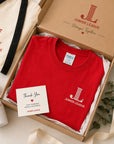 Junior League Women Who Build Essential Tee packaged in premium gift box with branded accessories and thank you card