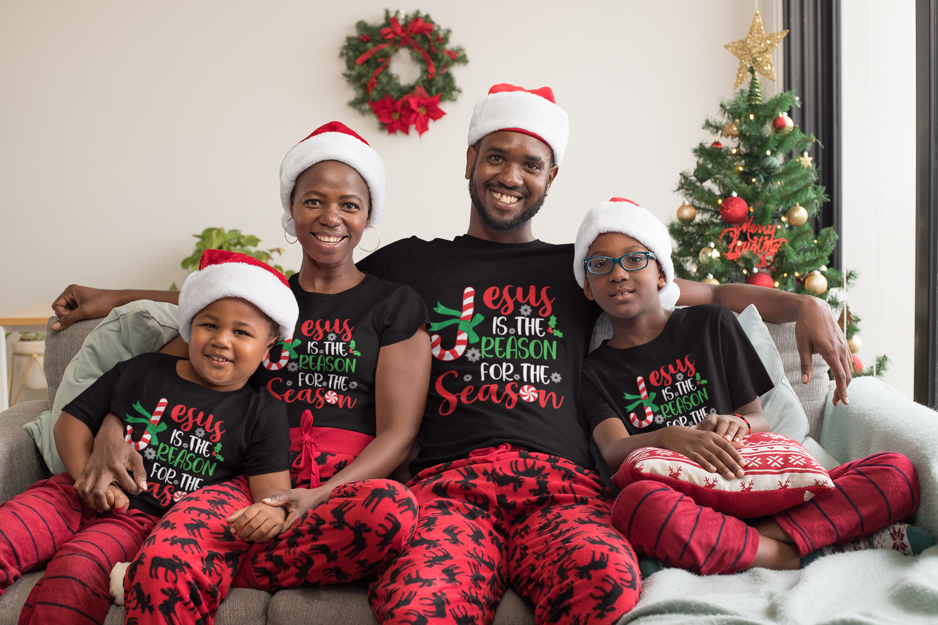 Black short-sleeve T-shirt with 'Jesus is the reason for the season' red/green print