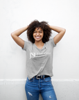 Unisex crew neck athletic heather grey T-shirt with Jackson State logo on chest, model wearing
