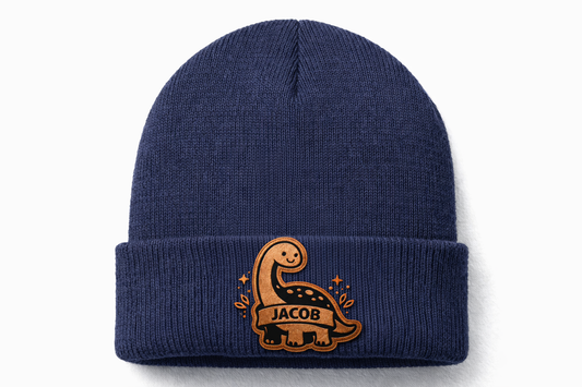 Navy blue beanie with a dinosaur design and 'Jacob' text on a white background