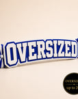 Oversized personalized acrylic name spirit stick from the Classic Collection featuring white, royal blue, and white three-layer acrylic with coordinating royal blue and white pom-poms, available up to 20 inches.