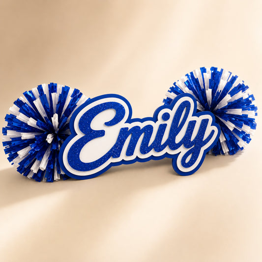 Personalized three-layer acrylic name spirit stick from the Classic Collection with coordinating pom-poms displayed on a luxury ivory background.