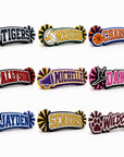 Nine personalized acrylic spirit stick designs featuring sports, cheer, dance, mascot, and senior themes in various school color combinations.